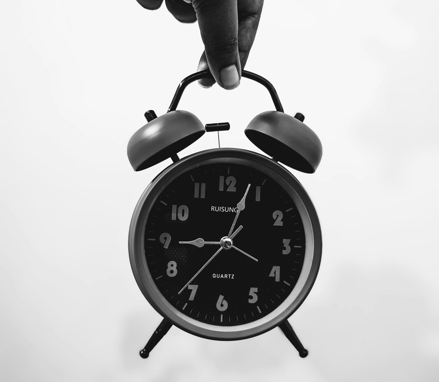 Wall clock on a wall, symbolizing manual time tracking and outdated employee management rituals